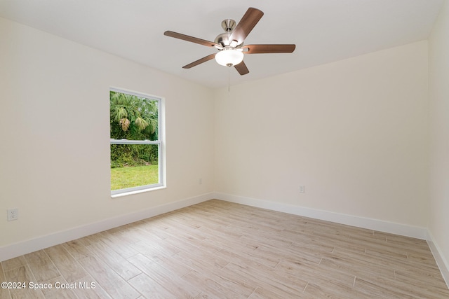 spare room featuring light wood-type flooring and ceiling fan