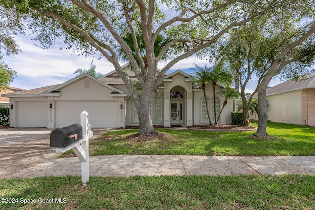 view of front of home featuring a garage and a front yard