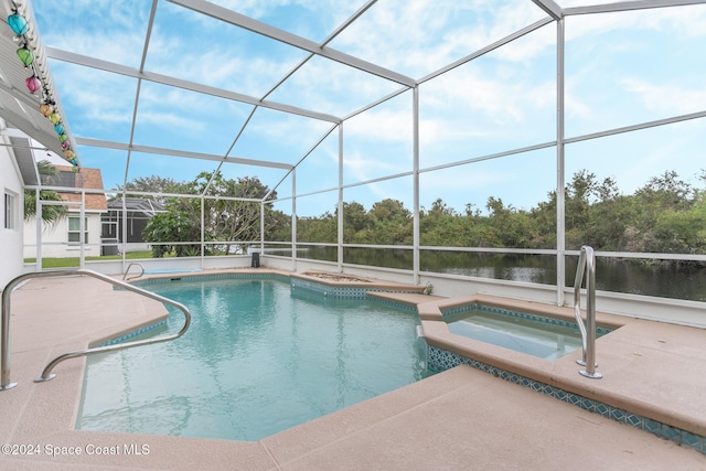 view of swimming pool with a patio area, a lanai, a pool with connected hot tub, and a water view