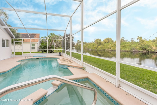 outdoor pool featuring a patio, an in ground hot tub, a water view, a lanai, and a yard