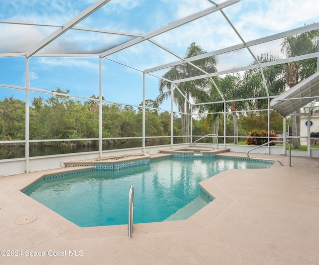 view of pool with a patio, a lanai, and a pool with connected hot tub