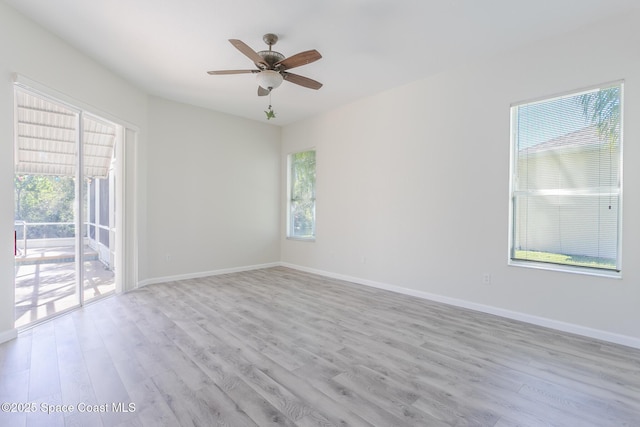 empty room featuring plenty of natural light, baseboards, and wood finished floors