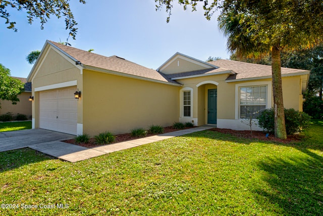 ranch-style house featuring a garage and a front yard