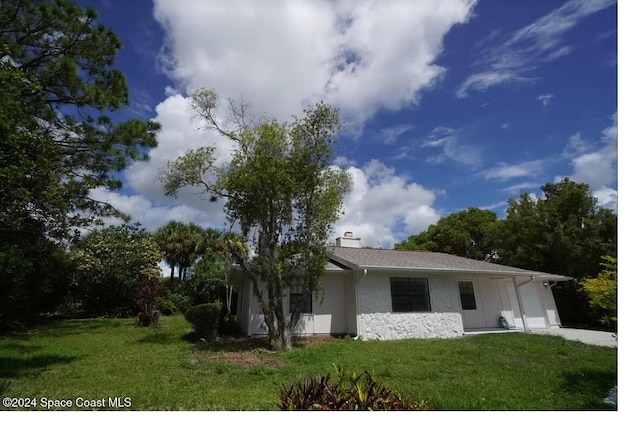 exterior space with a garage and a front lawn