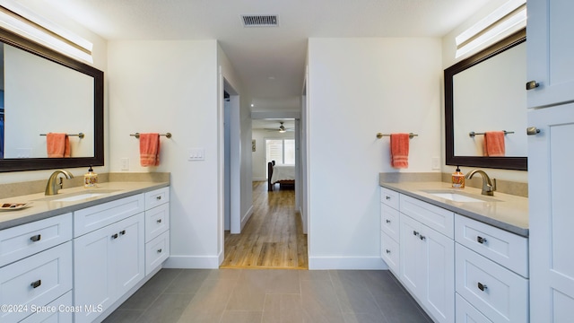 bathroom with hardwood / wood-style floors, vanity, and ceiling fan