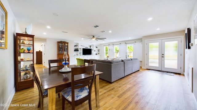 dining space featuring french doors, light wood-type flooring, and ceiling fan