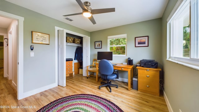 office with ceiling fan and light hardwood / wood-style flooring