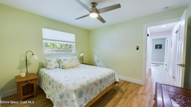 bedroom with hardwood / wood-style flooring and ceiling fan