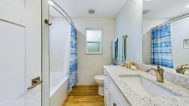 full bathroom featuring hardwood / wood-style floors, vanity, toilet, and shower / bath combination with curtain