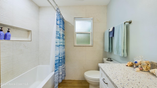 full bathroom with wood-type flooring, vanity, toilet, and shower / tub combo