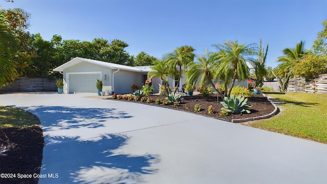 view of front of property with a garage and a front yard