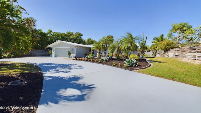 view of front of home featuring a garage and a front lawn