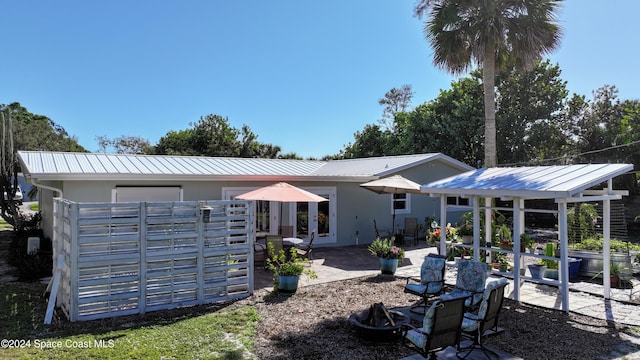 back of property featuring french doors and a patio area