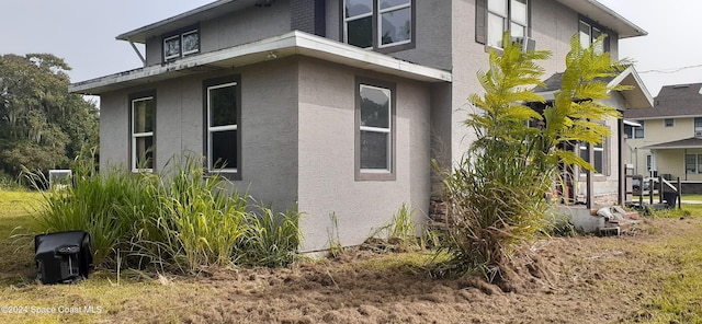 view of side of home featuring stucco siding