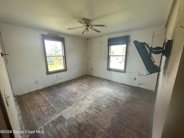 unfurnished room with a ceiling fan and wood-type flooring