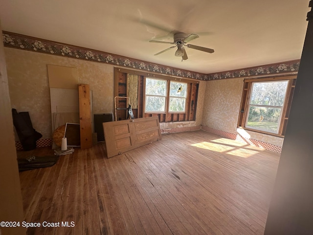 unfurnished bedroom featuring wallpapered walls and hardwood / wood-style flooring