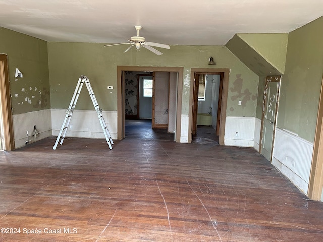 spare room with ceiling fan, hardwood / wood-style floors, and wainscoting