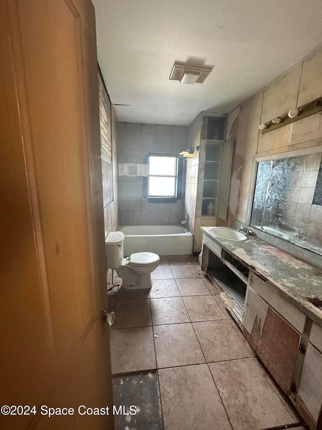 bathroom featuring tile patterned flooring, toilet, vanity, and  shower combination