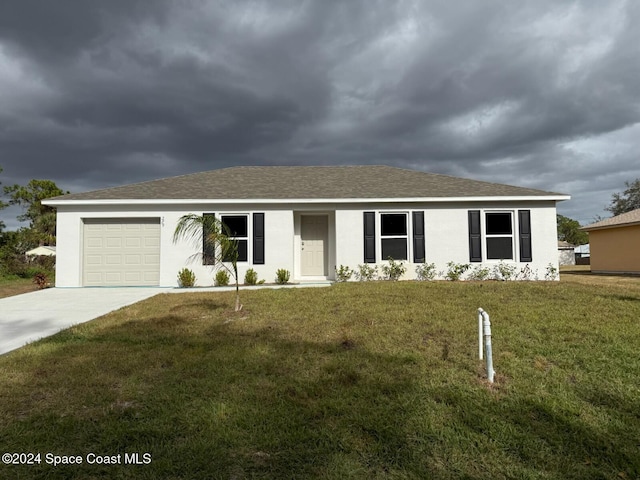 single story home featuring a garage and a front lawn