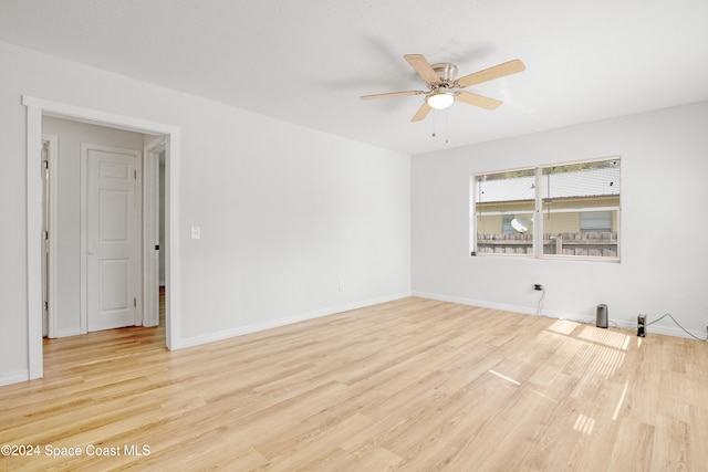 spare room featuring light hardwood / wood-style flooring and ceiling fan