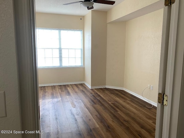 spare room featuring ceiling fan, a textured ceiling, and dark hardwood / wood-style floors