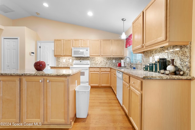 kitchen with hanging light fixtures, white appliances, vaulted ceiling, light brown cabinetry, and light hardwood / wood-style floors