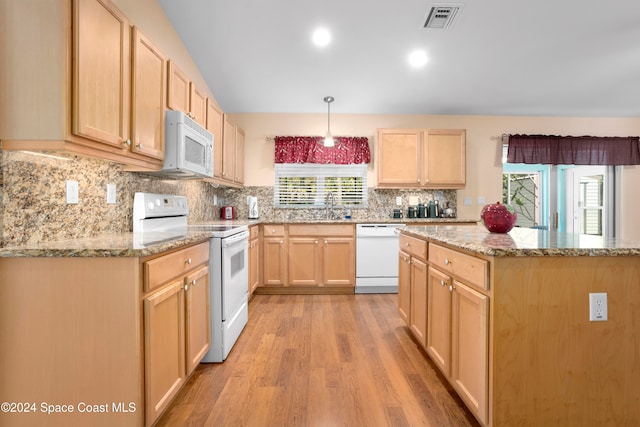 kitchen with white appliances, light brown cabinetry, light wood-type flooring, and hanging light fixtures