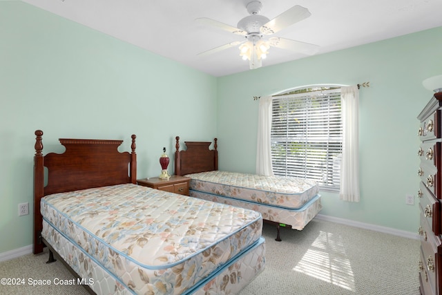 bedroom featuring ceiling fan and light colored carpet