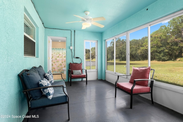 sunroom / solarium featuring ceiling fan