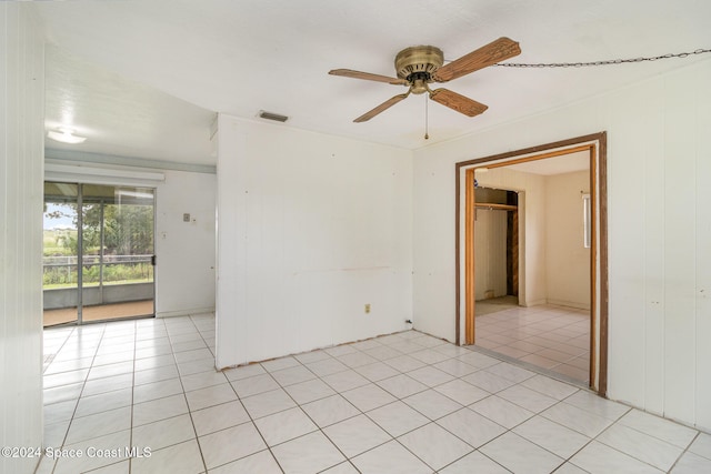 empty room with light tile patterned flooring and ceiling fan