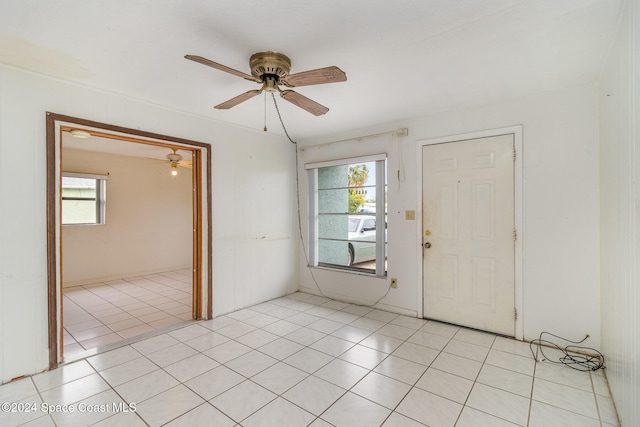 tiled entrance foyer featuring ceiling fan and a healthy amount of sunlight