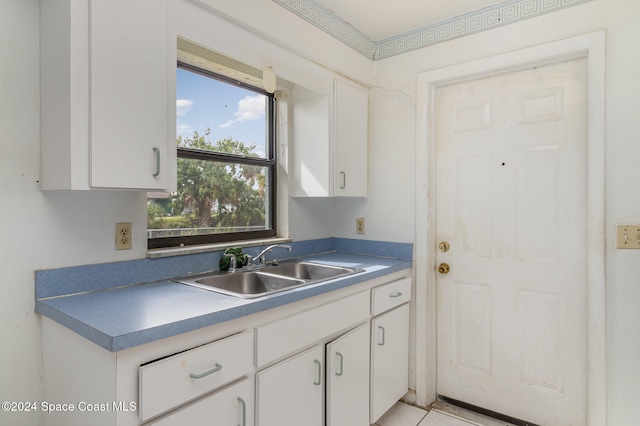 kitchen featuring white cabinets and sink