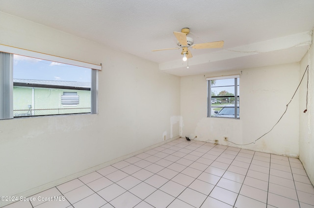 unfurnished room featuring light tile patterned floors and ceiling fan