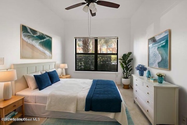 bedroom featuring light carpet and ceiling fan