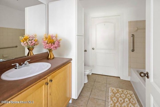 bathroom with vanity, toilet, and tile patterned flooring