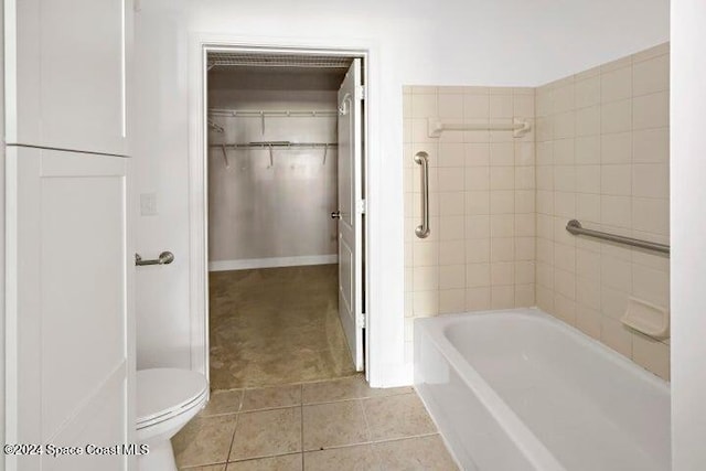 bathroom with toilet and tile patterned floors