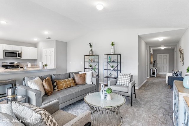 living room with lofted ceiling and light colored carpet