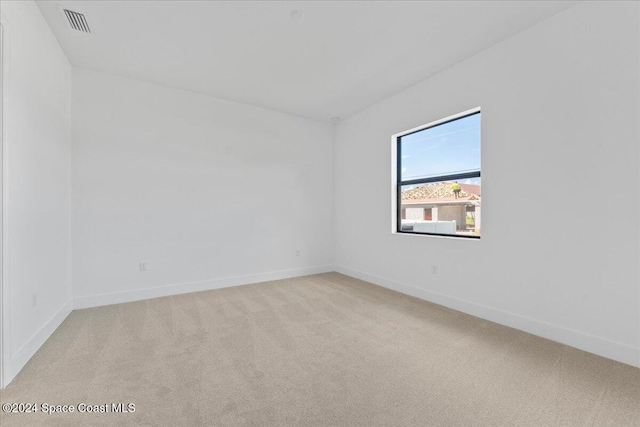 spare room with light colored carpet