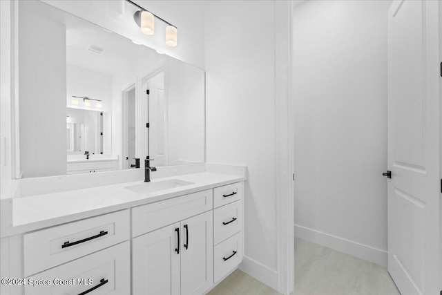 bathroom with vanity and baseboards