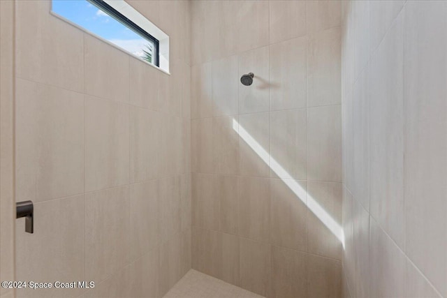 bathroom with a tile shower