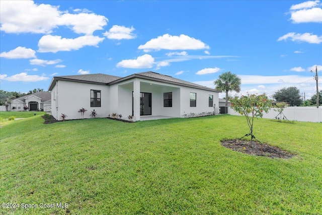 rear view of house with a yard