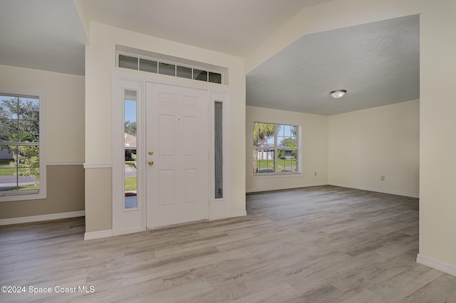 entrance foyer with light wood-type flooring and a wealth of natural light