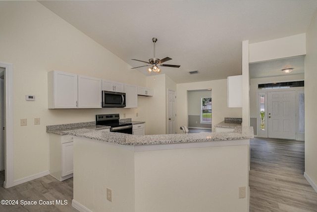 kitchen with light wood-type flooring, appliances with stainless steel finishes, vaulted ceiling, white cabinets, and kitchen peninsula