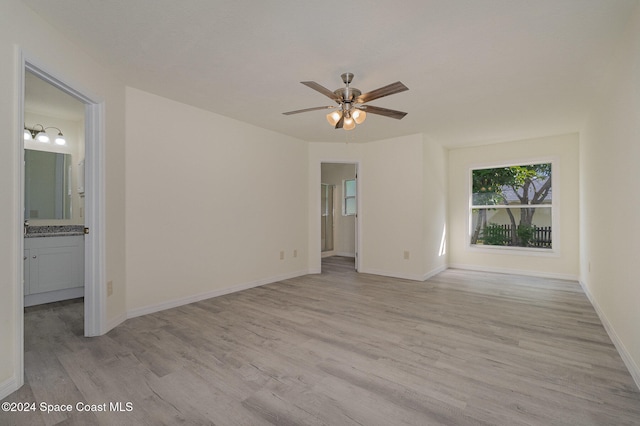 empty room featuring light wood-type flooring and ceiling fan