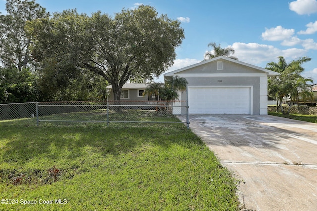 view of front of home featuring a front lawn and a garage