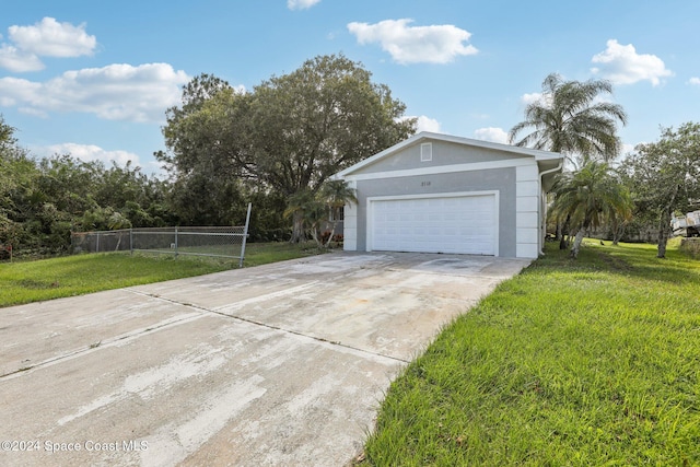 view of home's exterior with a garage and a yard