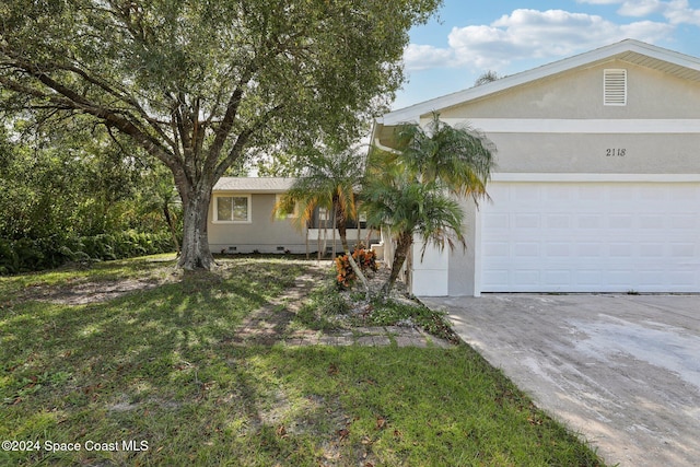 single story home featuring a front yard and a garage