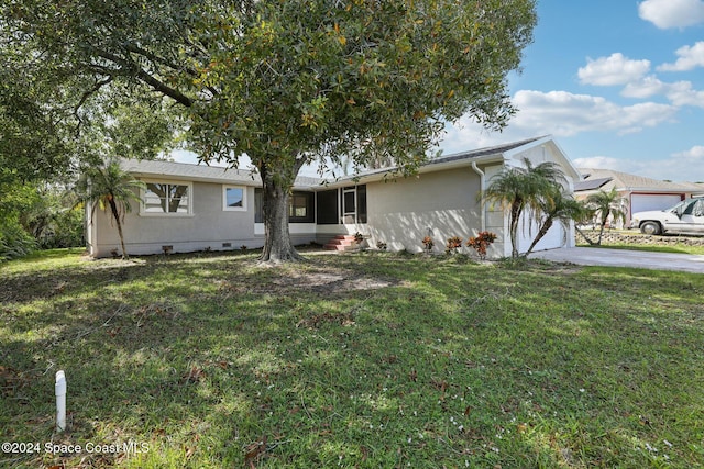 single story home with a garage and a front lawn