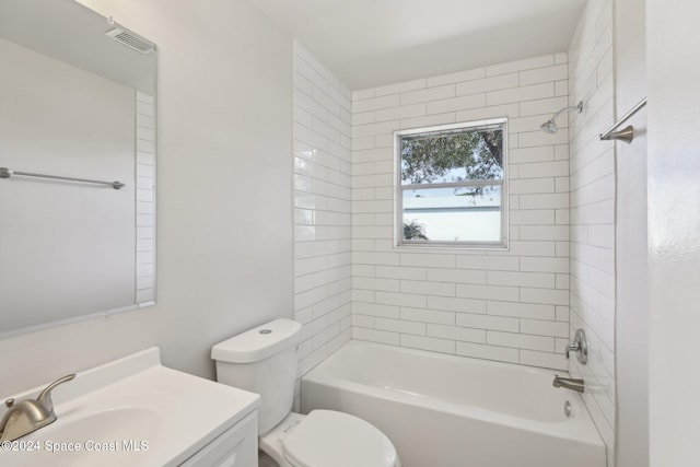 full bathroom featuring vanity, tiled shower / bath combo, and toilet