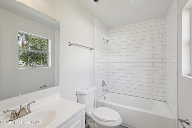 full bathroom featuring toilet, vanity, and tiled shower / bath combo